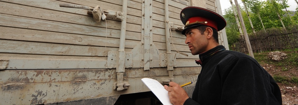 Customs official inspects truck in Tajikistan
