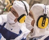 Employees in PPE protective suits