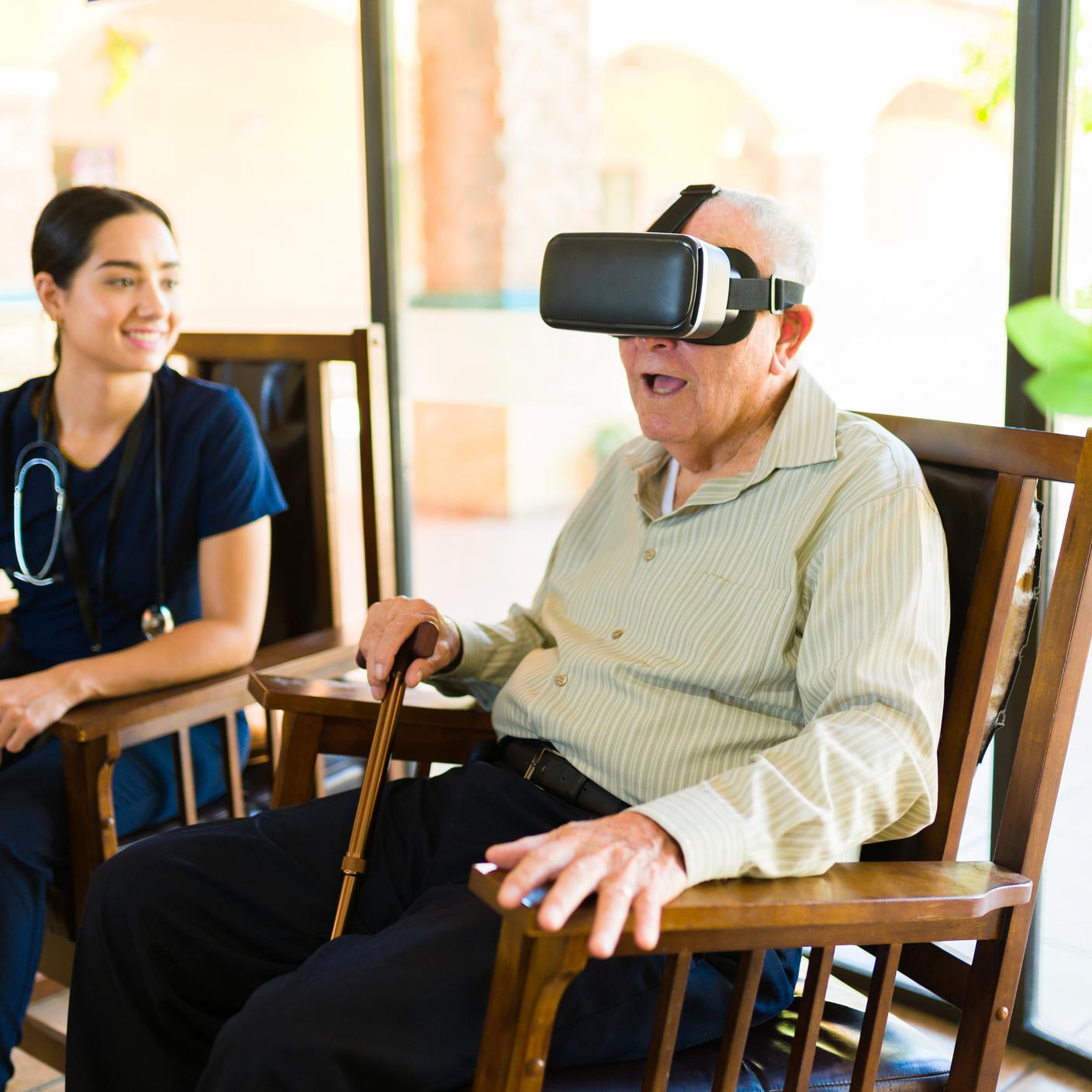 Elderly gentleman having fun at the nursery home while playing with virtual reality glasses