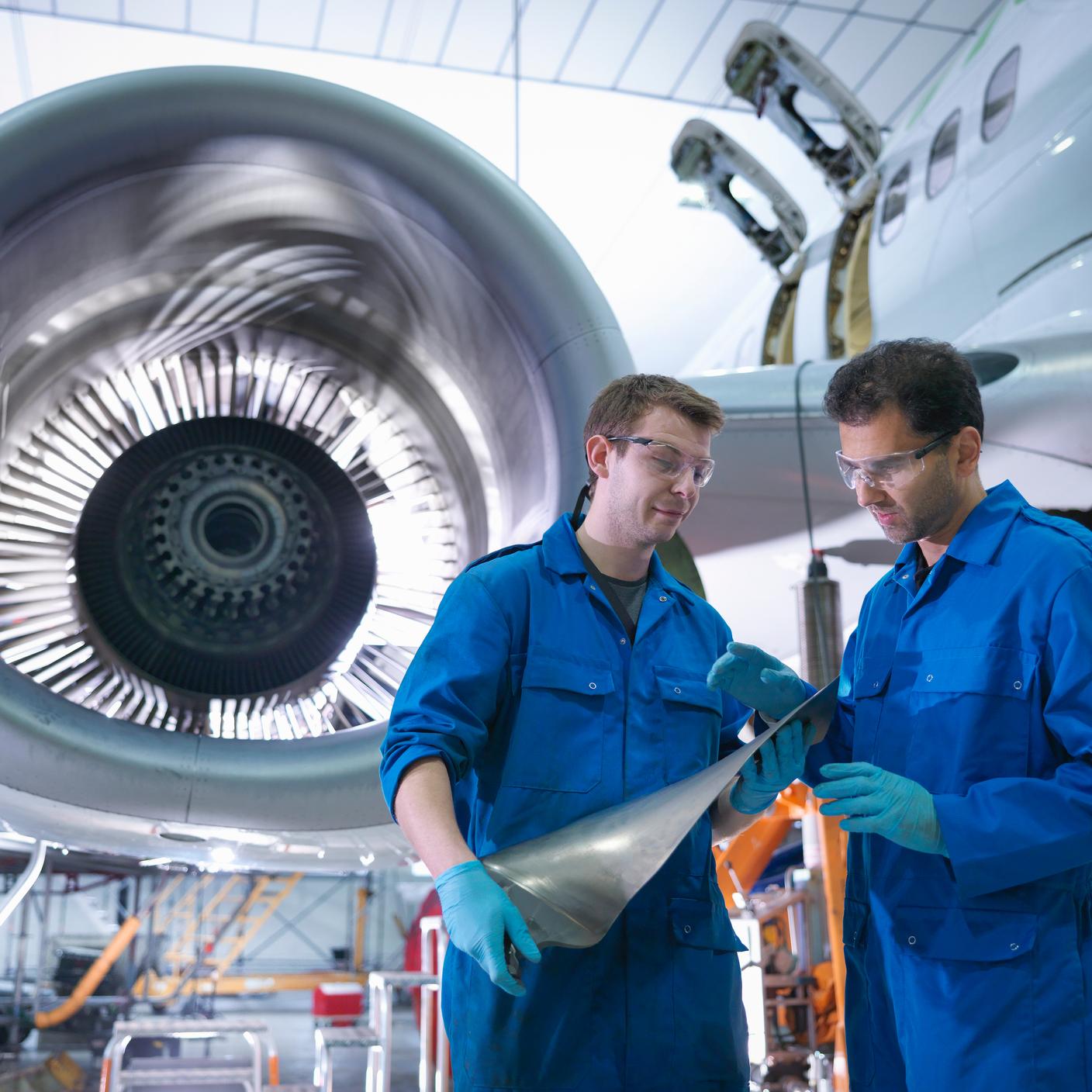Transport and mobility - men in front of plane turbine