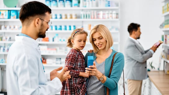 Enhancing Customer Satisfaction - Close up of a mother and daughter looking at products in the pharmacy 