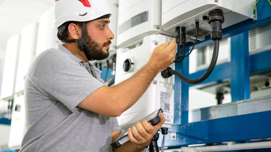 A man checks the integrity of the connector cables