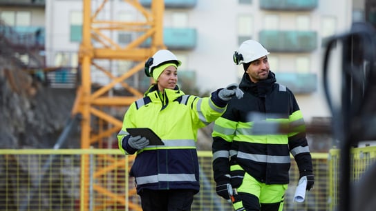 Two construction engineers working at construction site