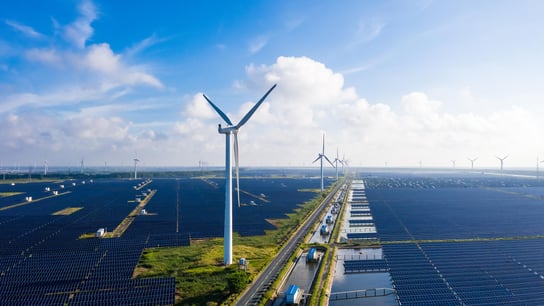 Solar power stations in plain areas, wind turbines in the distance