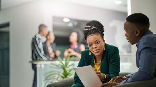 Business people brainstorming in office lobby