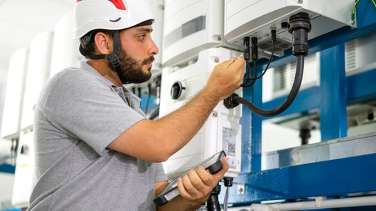 A man checks the integrity of the connector cables