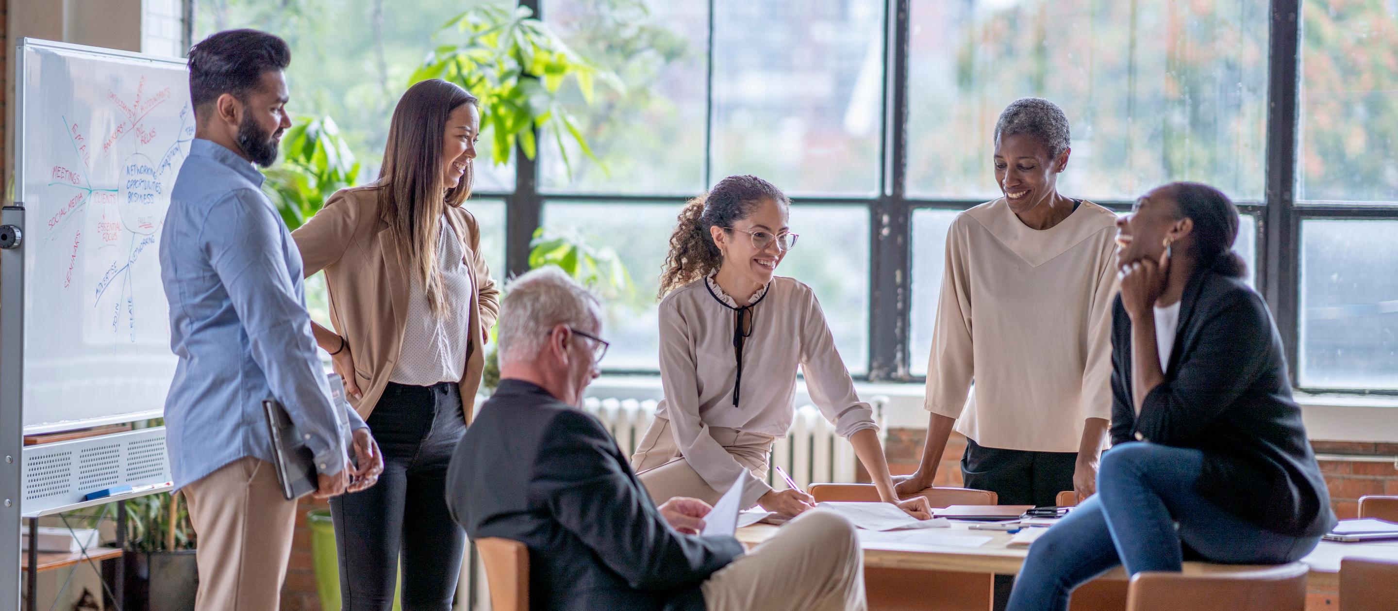 Group of people interacting in a meeting at a table