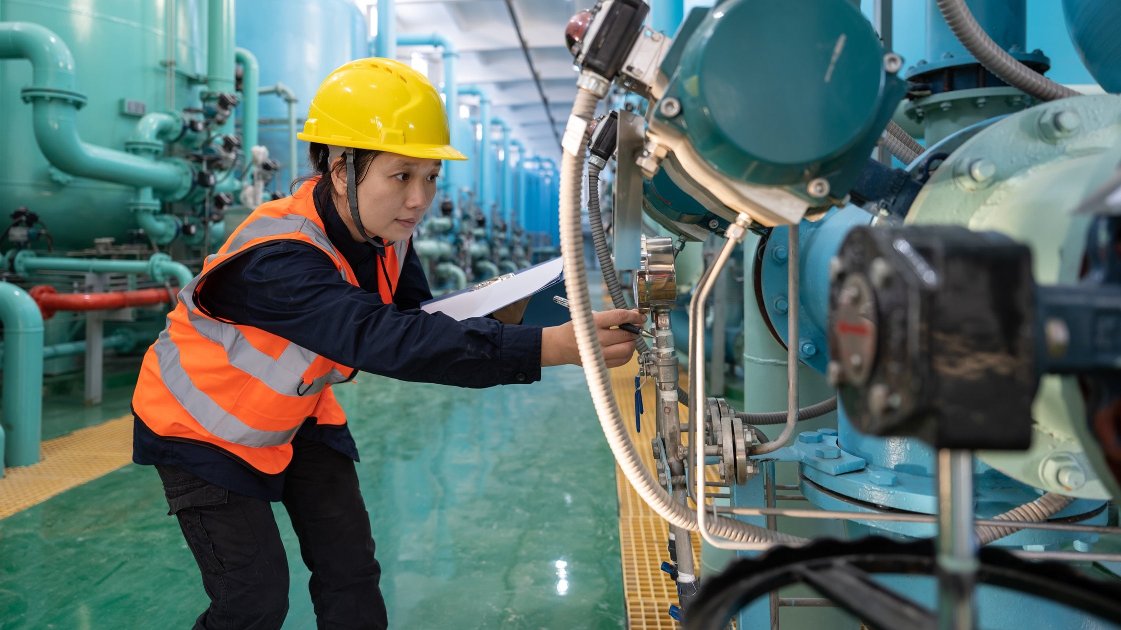 A female technician works in a chemical plant