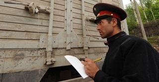 Customs official inspects truck in Tajikistan
