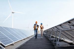 Two people inspecting solar panels