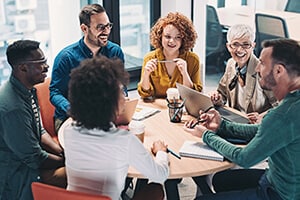 Group of office workers sitting around a table