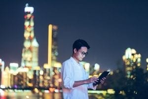 Man looking at tablet in city