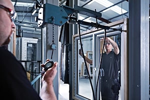 Two men working on window testing