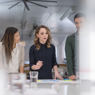 Three people discussing at a table