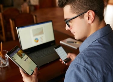 Man looking at devices