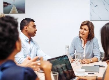 team-meeting-at-table-with-laptop