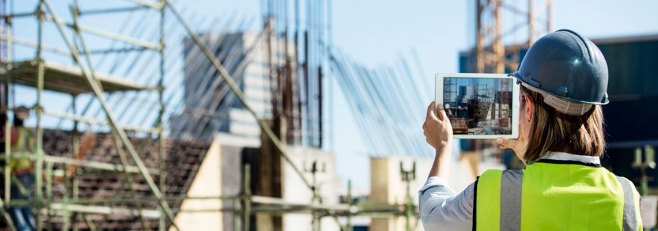 Woman holding tablet at construction site