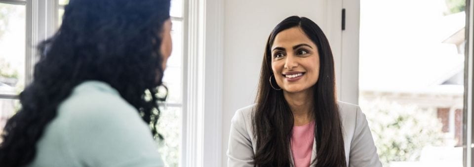 Woman speaking to colleague in business setting