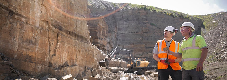 Workers inspecting rock starta Audit