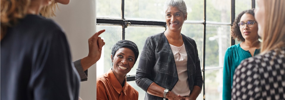 group of women having a discussion at work