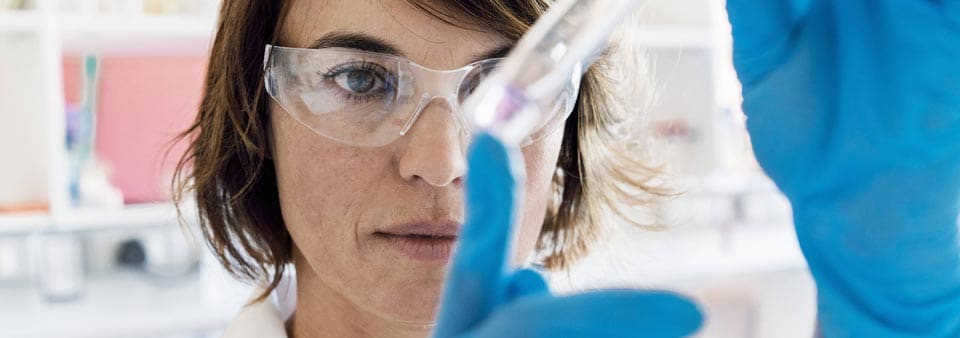 medical specialist women looking at test tube