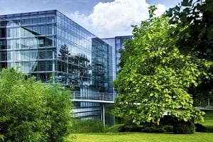 Glass building with green trees