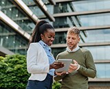 Image of two people looking at an ipad