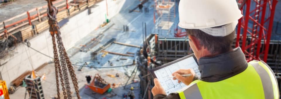 Civil engineer in a construction site working on a tablet