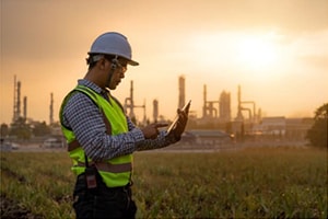 A architect looking at a laptop on a building site