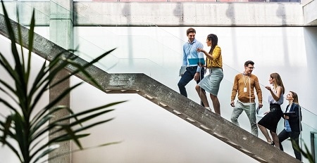Professional team of people walk up stairs in a modern office_450×232.jpg