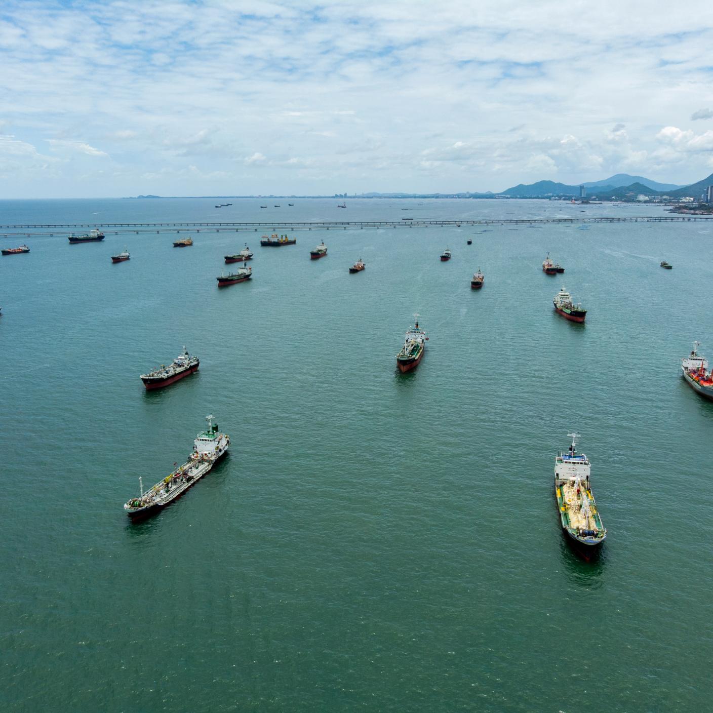 Oil tankers and gas tankers and supply chain cargo container ships were affected by the closure of the Strait of Hormuz, leading to a global energy crisis stemming from the war in the Middle East. Aerial view