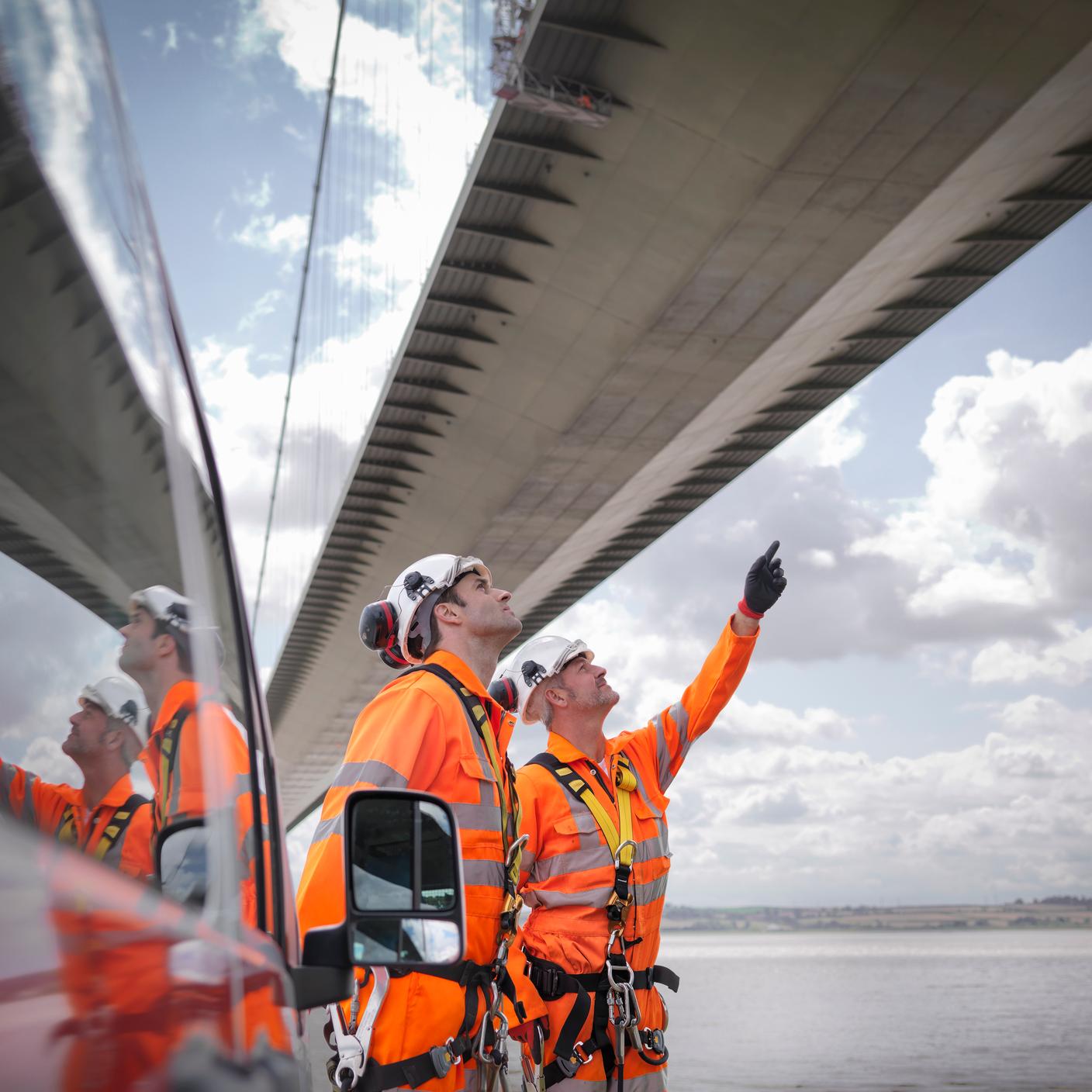 built environment two men building a bridge