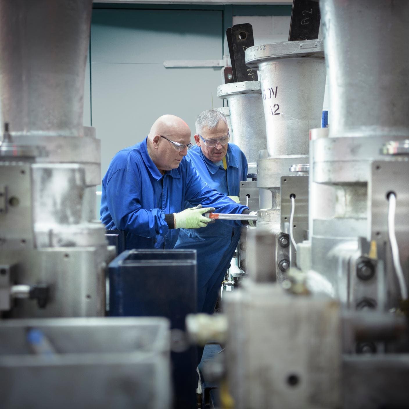 Case study – ANSTO BSI certification to ISO 45001 - Two engineers inspecting a valve in a nuclear power station