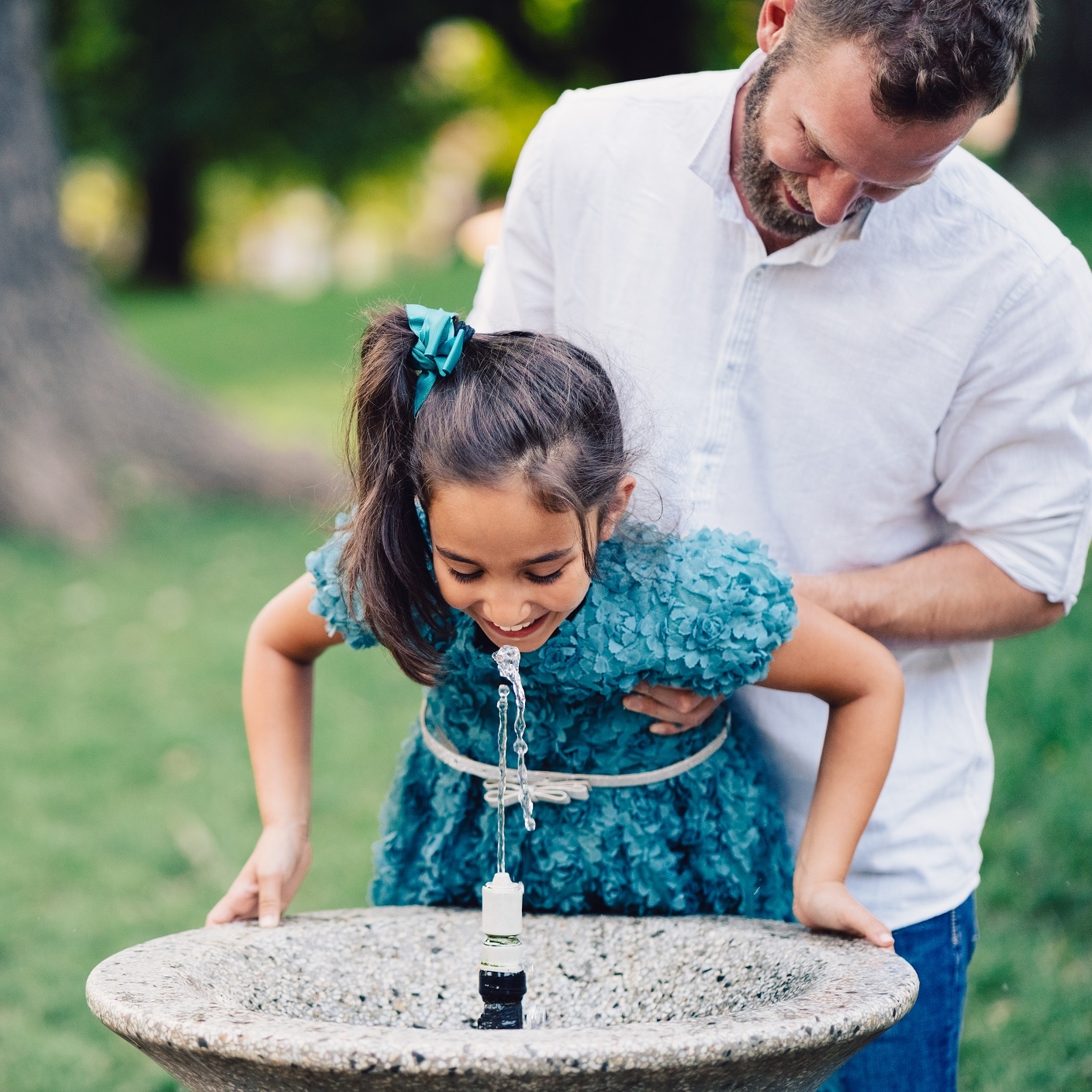 Healthcare : A little girl drinking while at a fountain