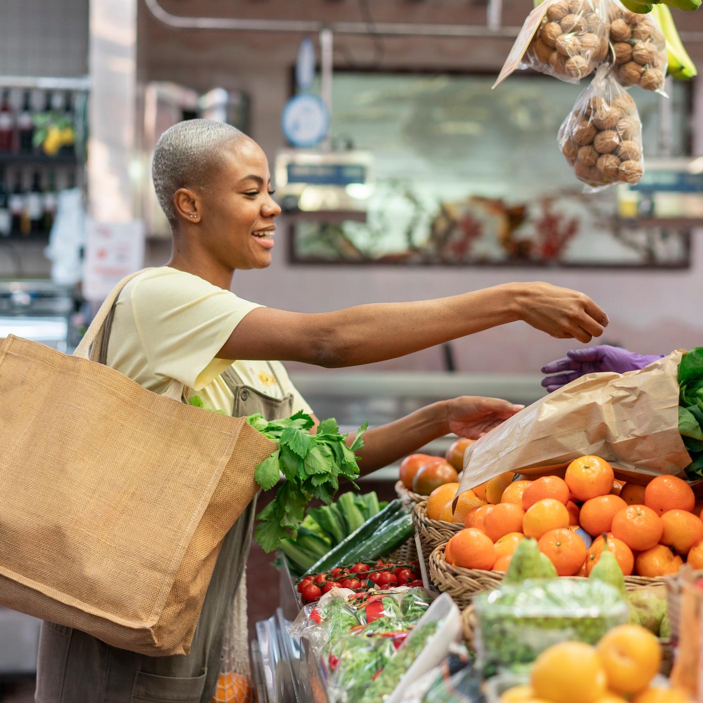 Supply chain - woman picking vegetables in supermarket