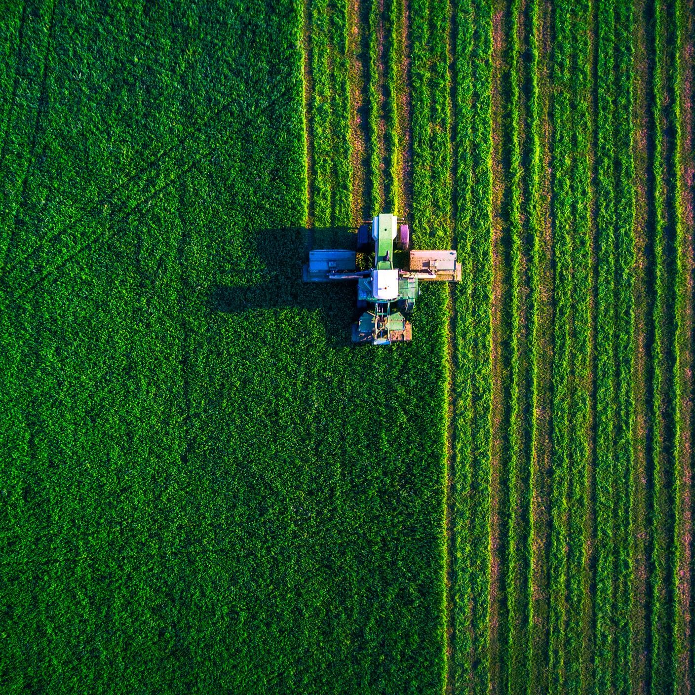 Sustainability in food and retail - tractor in field on hoverhead view
