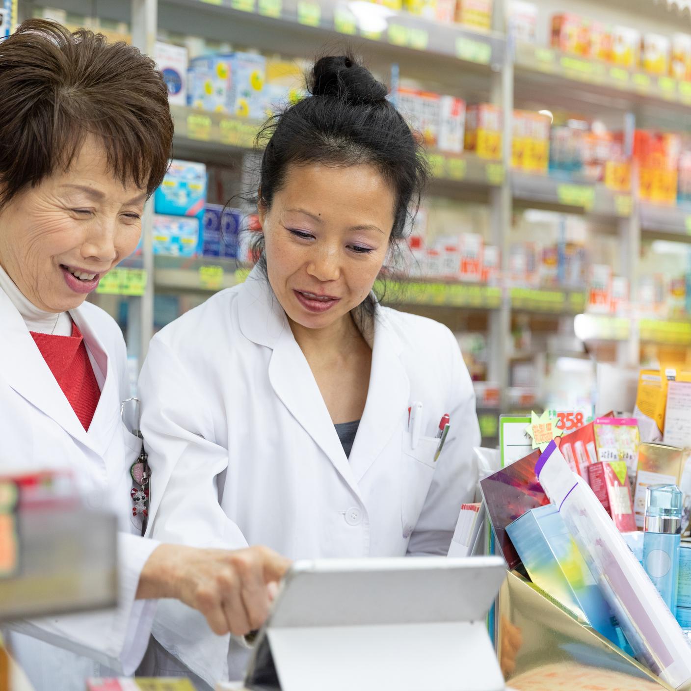 Two japanese women discussing in a pharmacy