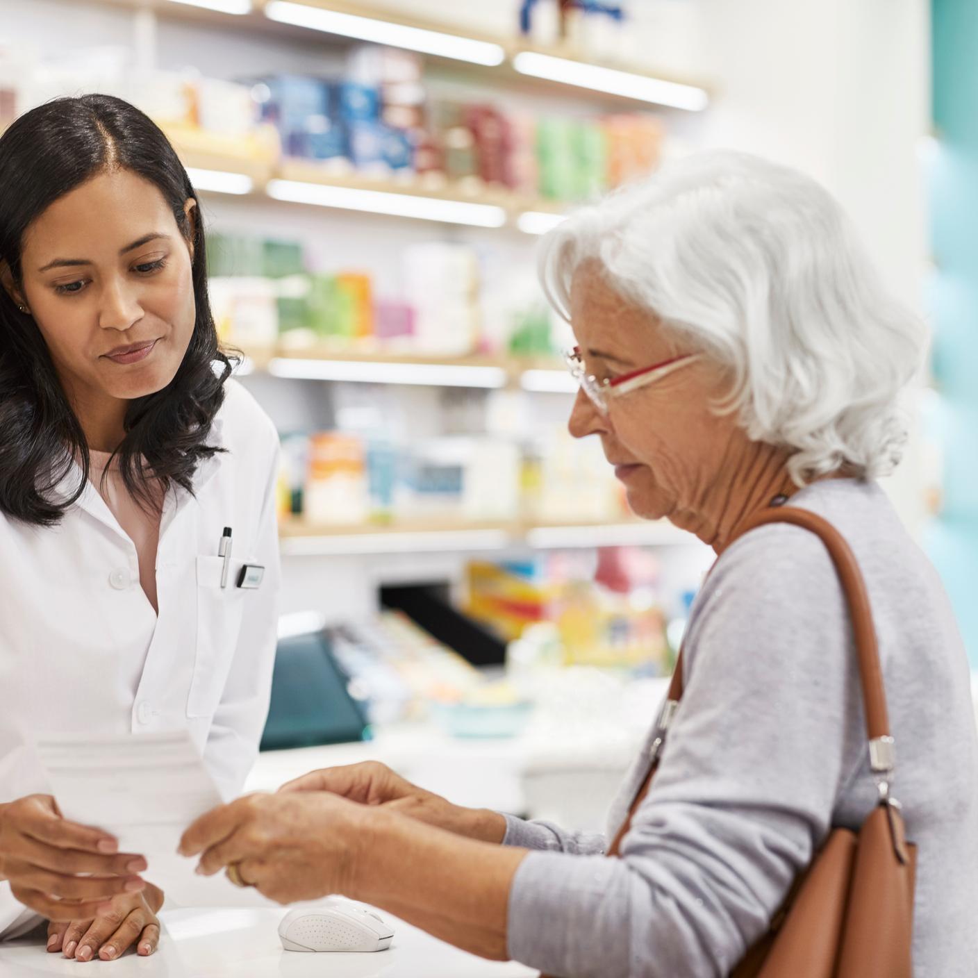 government - elderly woman at pharmacy counter