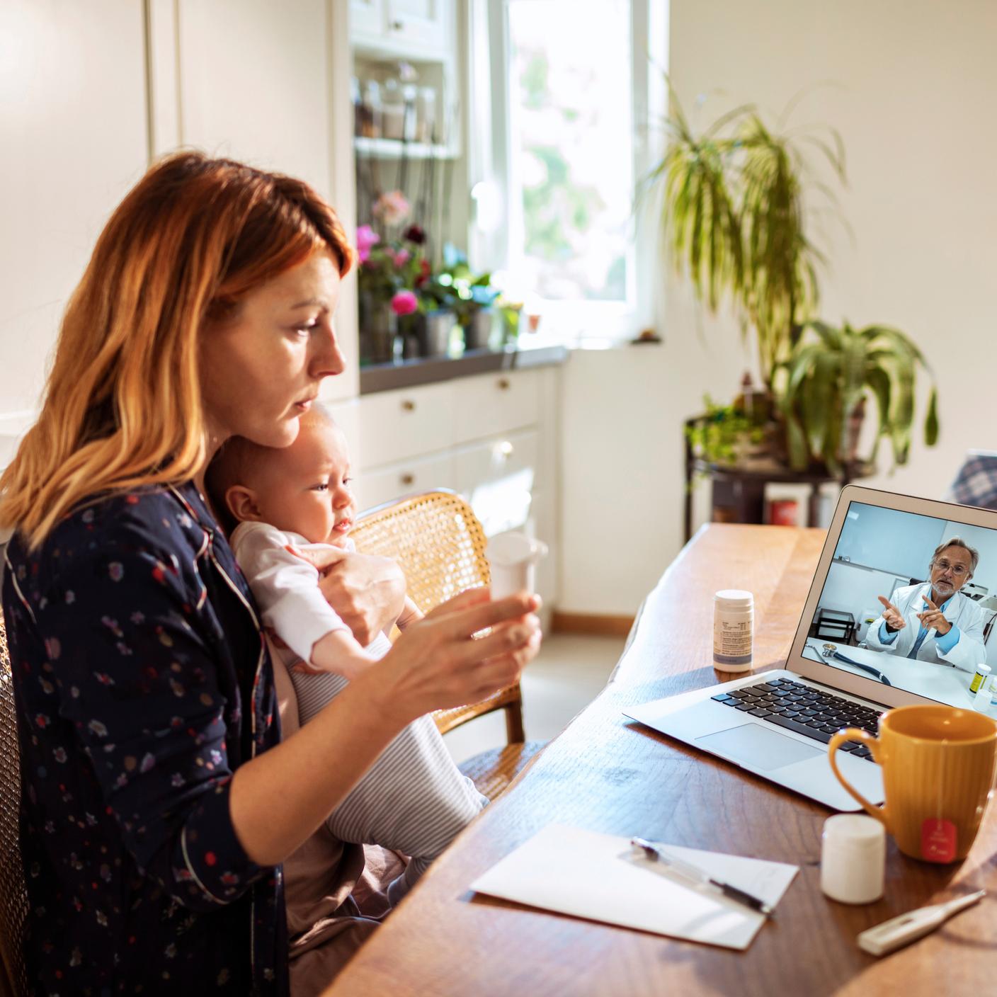 A woman with her child in a virtual meeting