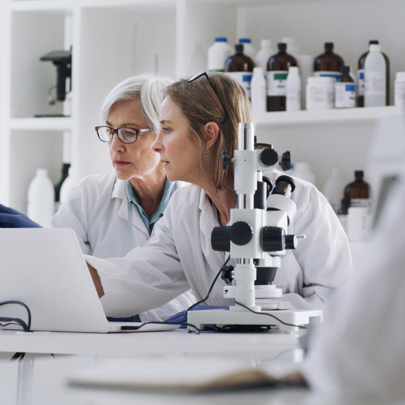 Two women discussing about medical results on their laptop