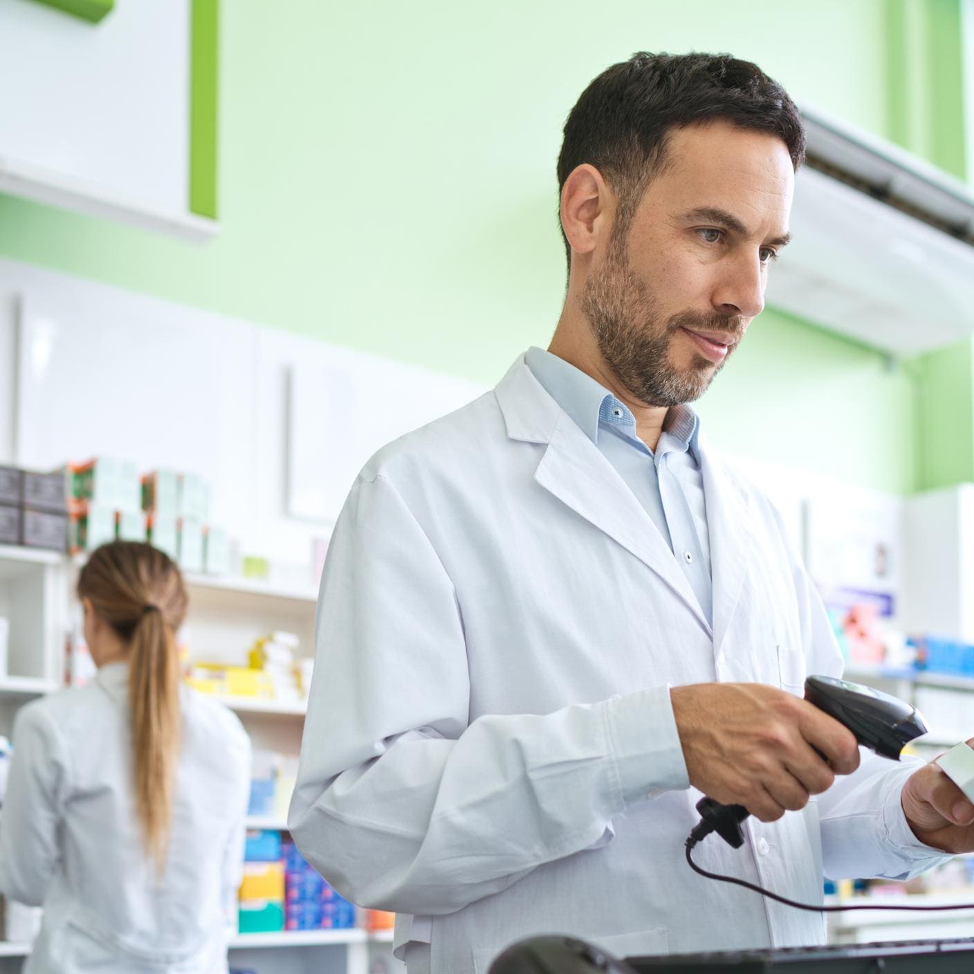 Transforming Aidtrust - Male pharmacist using bar code