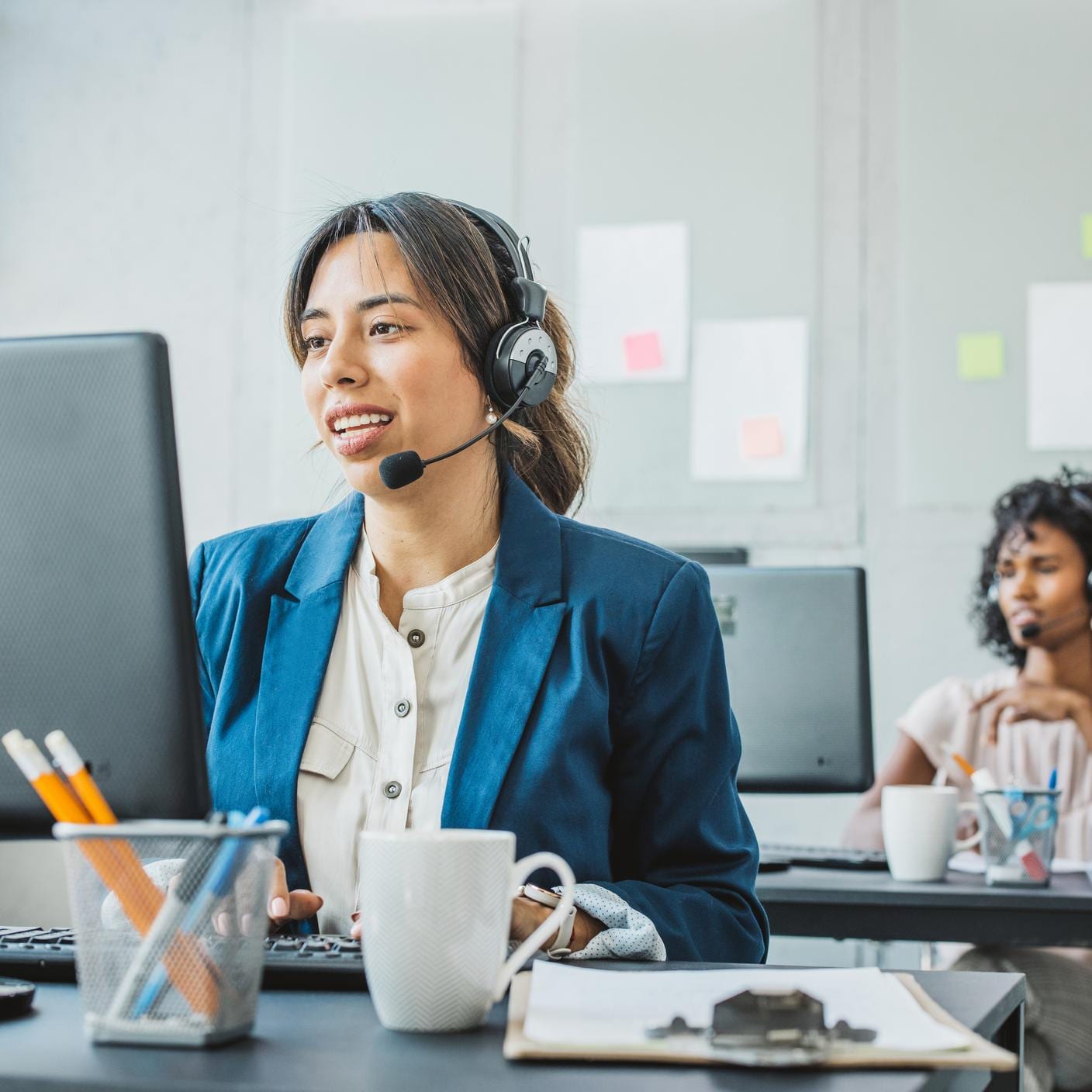 Friendly woman in call center service talking with costumers