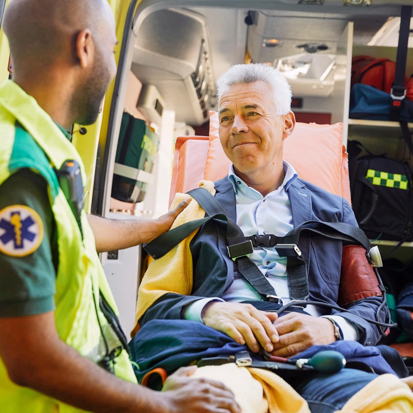 Paramedic consoling patient in ambulance