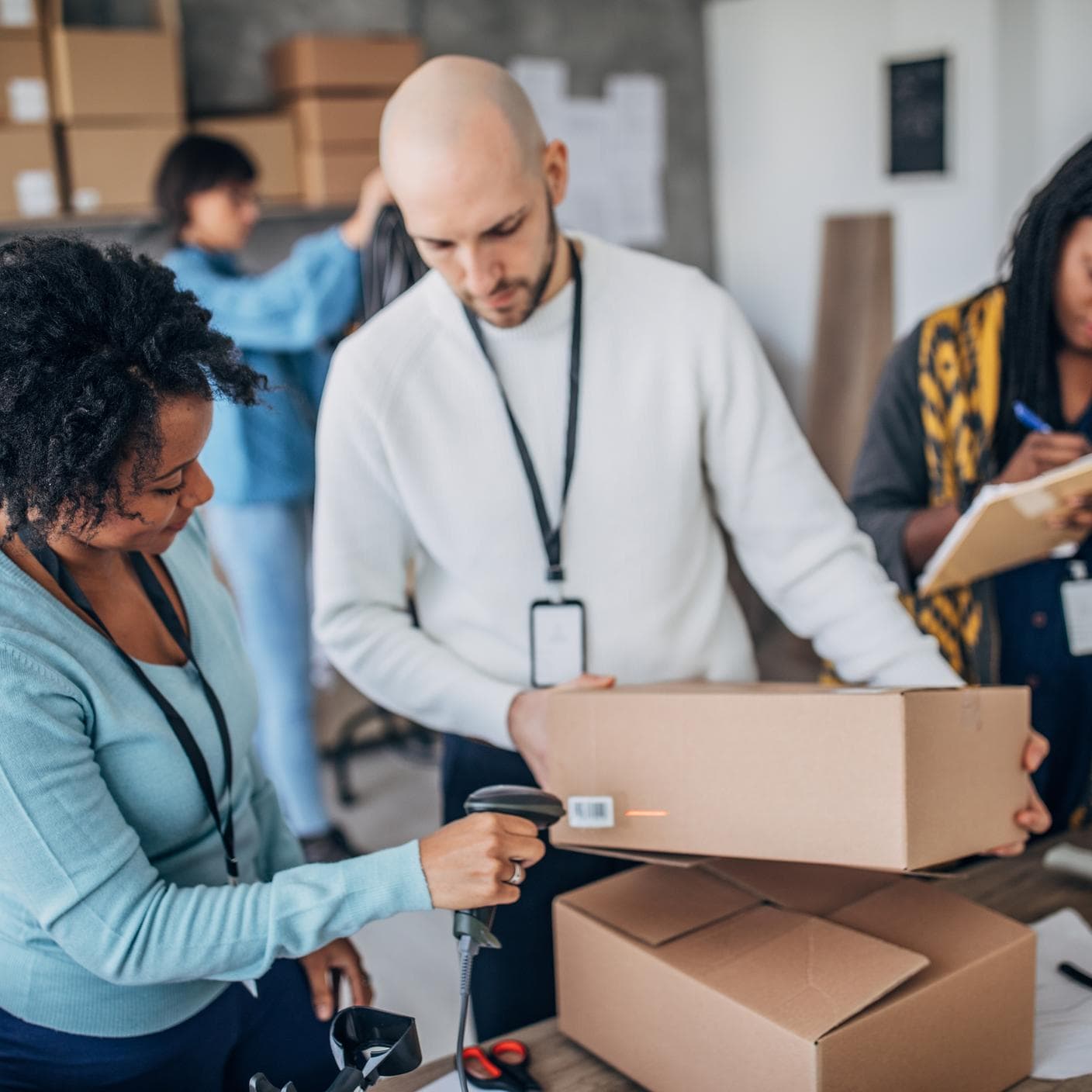 Workers arranging customers orders for drop shipping in warehouse