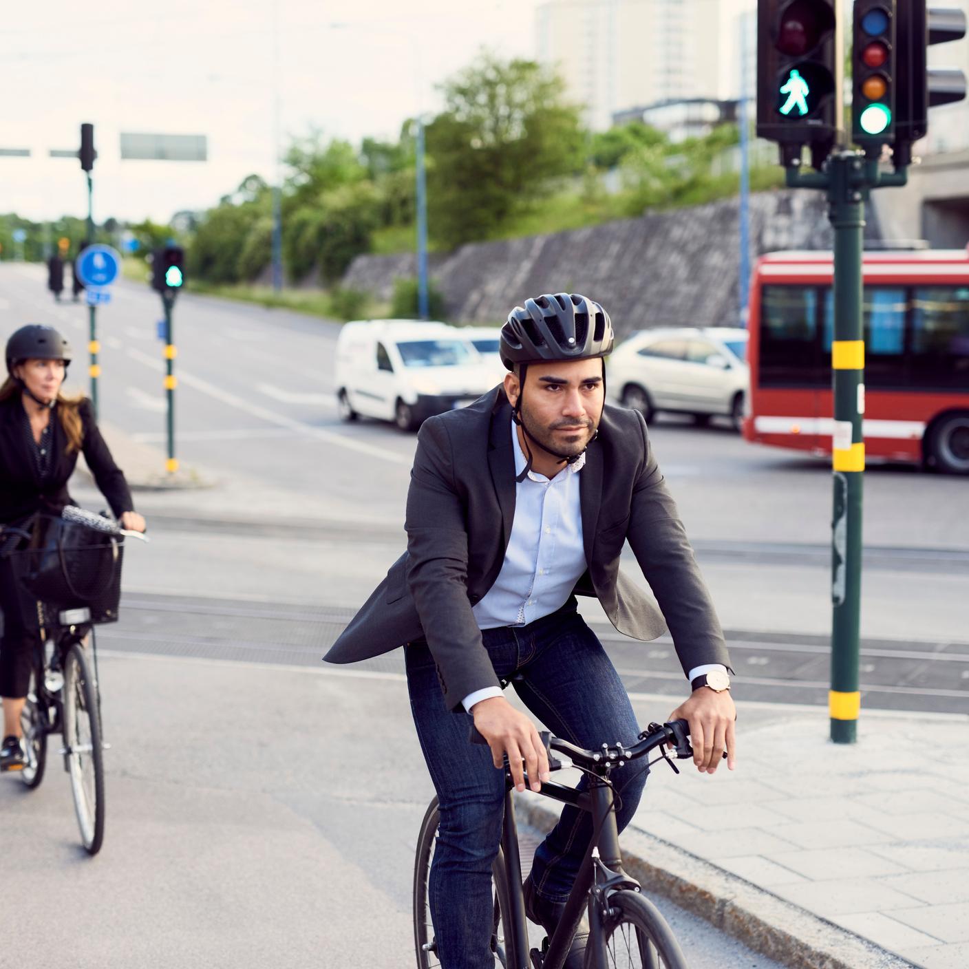 Businesspeople cycling on street in city
