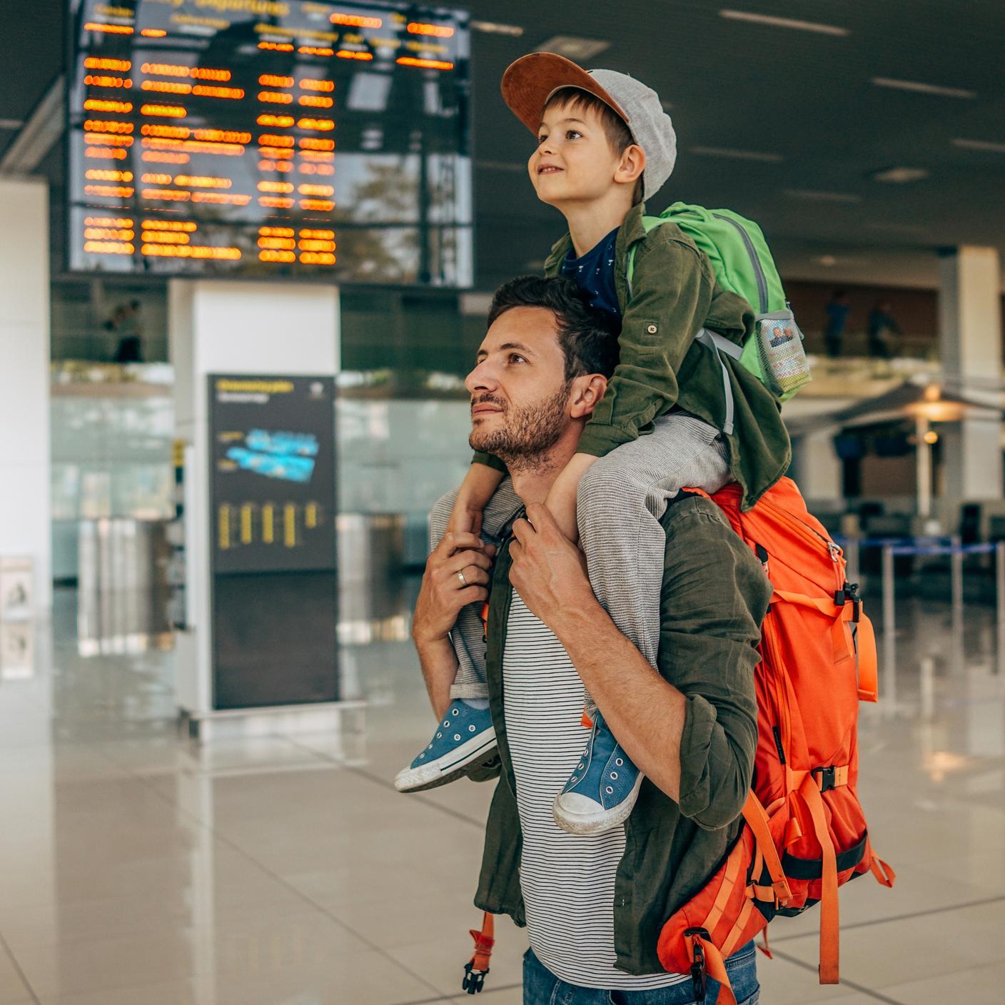 Digital trust in transport and mobility - father and son at train station