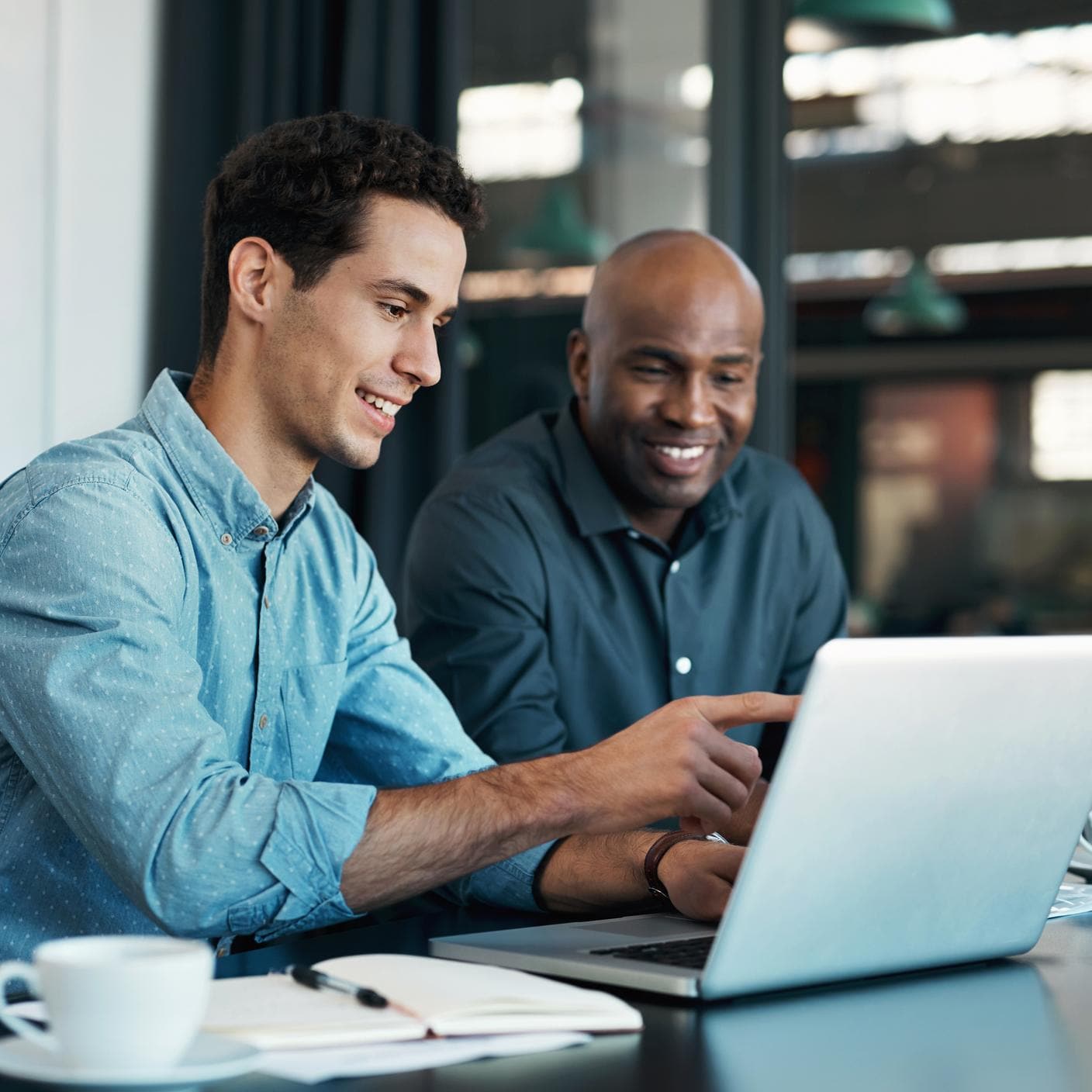 Teamwork, diversity and sales manager planning branding ideas with a creative designer on a laptop