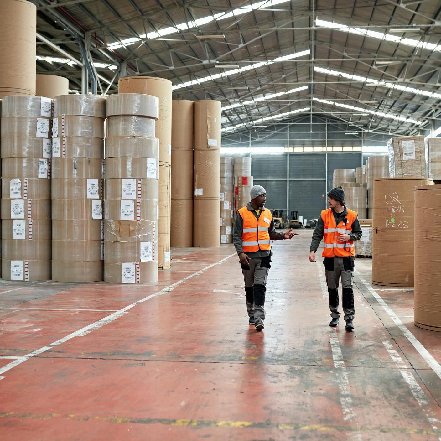 members of a trade association - two people walk towards camera in distribution center
