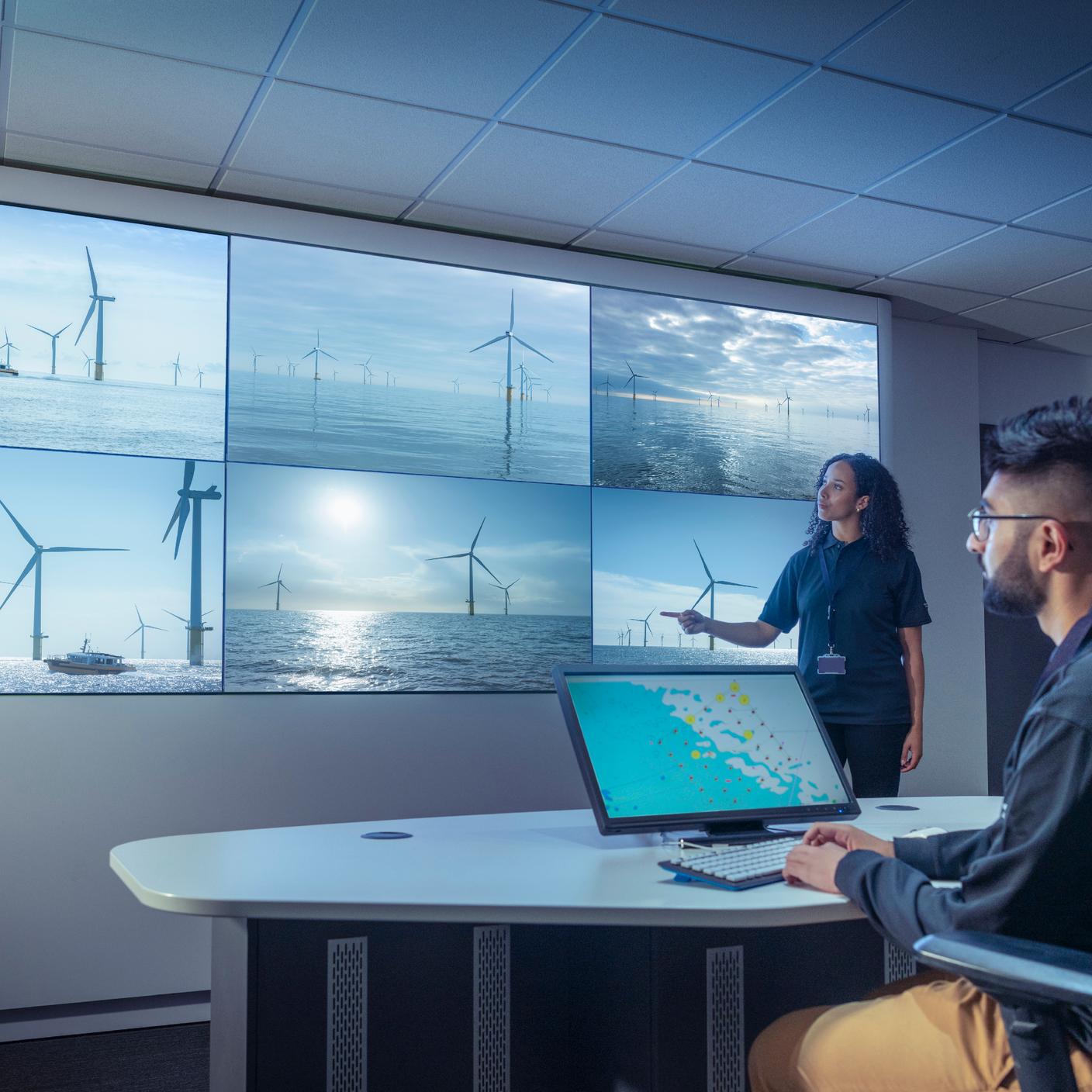 BS EN ISO 50005 - UK, York, Male and female operators in offshore wind farm control room