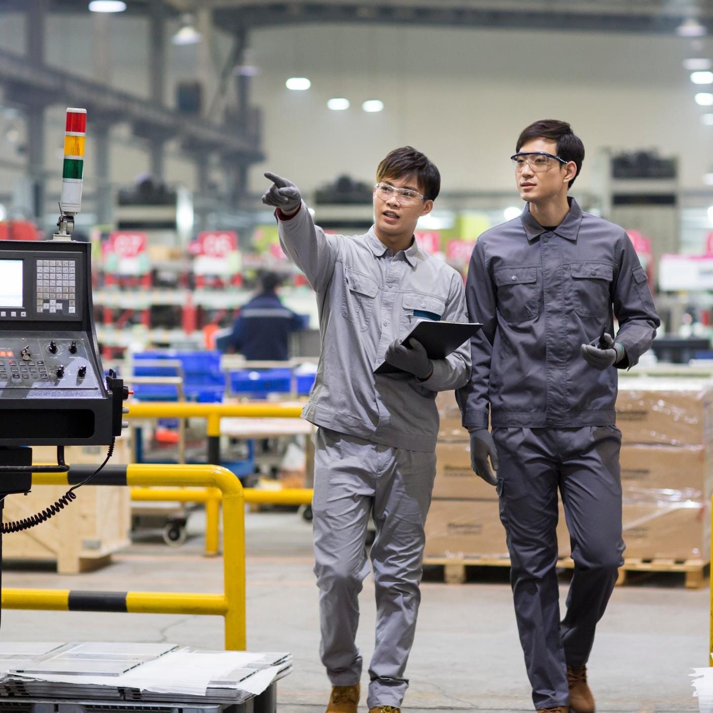 Confident engineers talking in the factory, Beijing, China